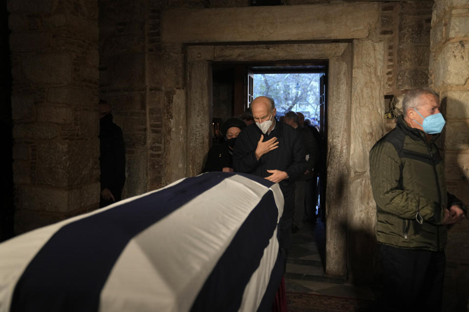 Men pay their respect to the former king of Greece Constantine in the Chapel of Saint Eleftherios in Athens, Monday, Jan. 16, 2023. Constantine died in a hospital late Tuesday at the age of 82 as Greece's monarchy was definitively abolished in a referendum in December 1974. (AP Photo/Petros Giannakouris)