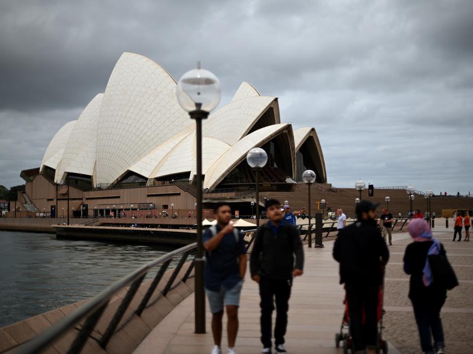 People visit the Opera House in Sydney on December 30, 2020, as authorities work to suppress a growing cluster of Covid-19 coronavirus cases in Australia's most populous city.