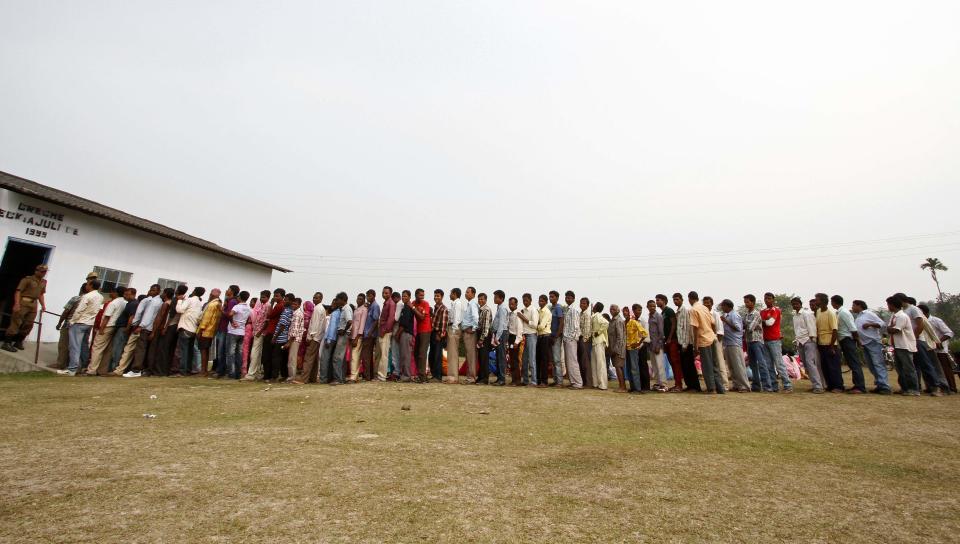 People line up to cast their vote outside a polling station at Dhekiajuli in Sonitpur district in the northeastern Indian state of Assam April 7, 2014. (REUTERS/Utpal Baruah)