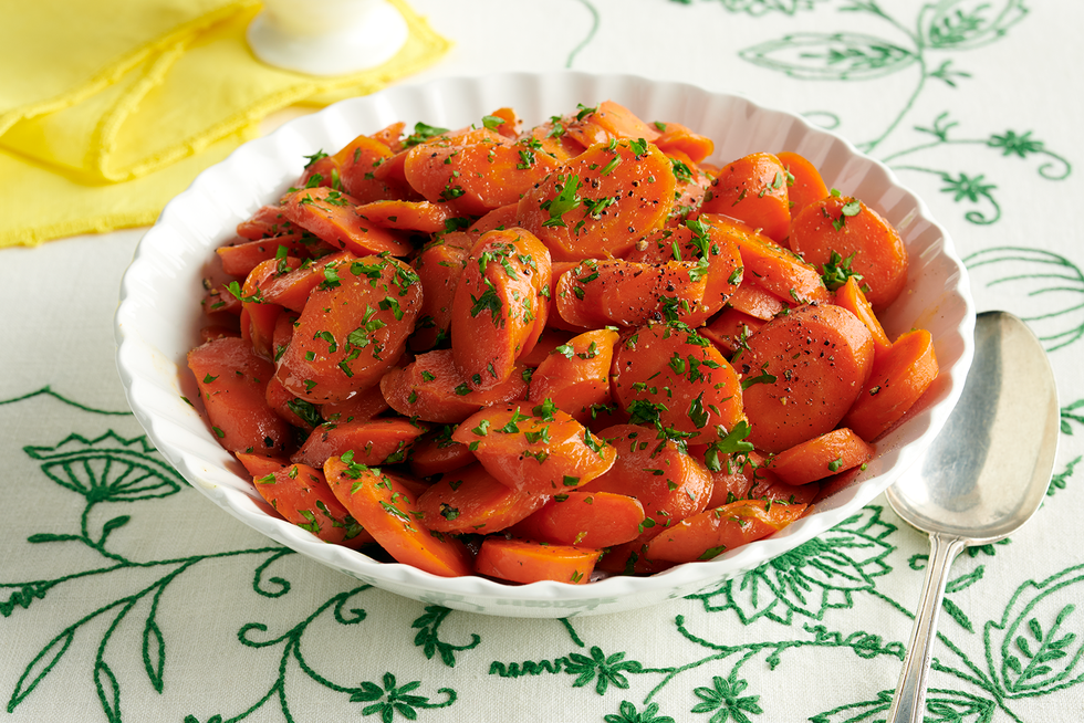 candied carrots with green herbs on top