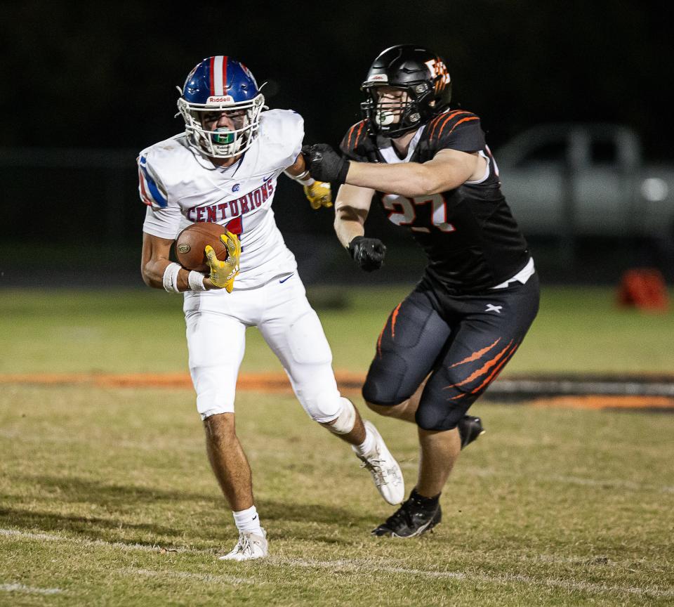 Christian Academy's Connor Hodge (1) breaks a tackle after intercepting a pass during the first half when the CAL Centurions face the Fern Creek Tigers on Friday, October 27, 2023.