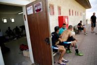 Players from Israeli soccer clubs affiliated with Israel Football Association, Ariel Municipal Soccer Club and Maccabi HaSharon Netanya, wait near their dressing rooms ahead of their match at Ariel Municipal Soccer Club's training grounds in the West Bank Jewish settlement of Ariel September 23, 2016. Picture taken September 23, 2016. REUTERS/Amir Cohen