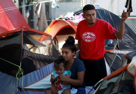 Honduran migrants Marvin Madrid and his new wife Dexy Maldonado speak during an interview with Reuters in an encampment in Matamoros