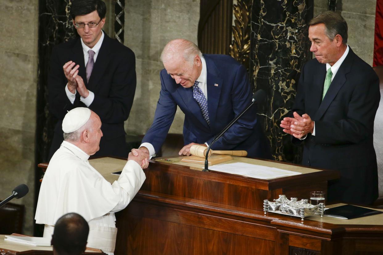 In this Sept. 24, 2015 photo then-Vice President Biden shakes hands with Pope Francis on Capitol Hill in Washington.