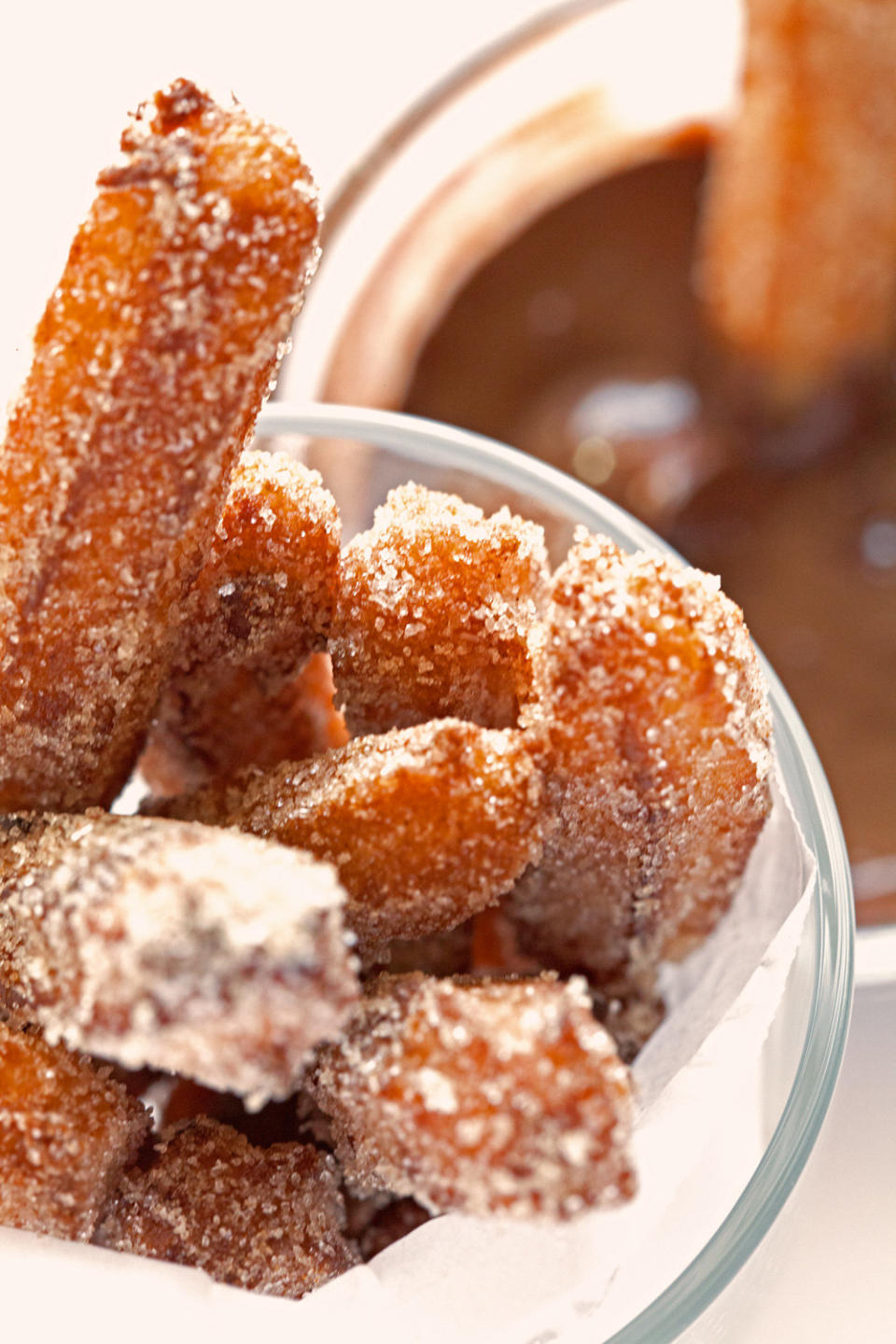 Cinnamon sugar churro sticks with melted chocolate sauce.