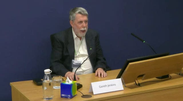 Gareth Jenkins seated at a desk and speaking into a microphone