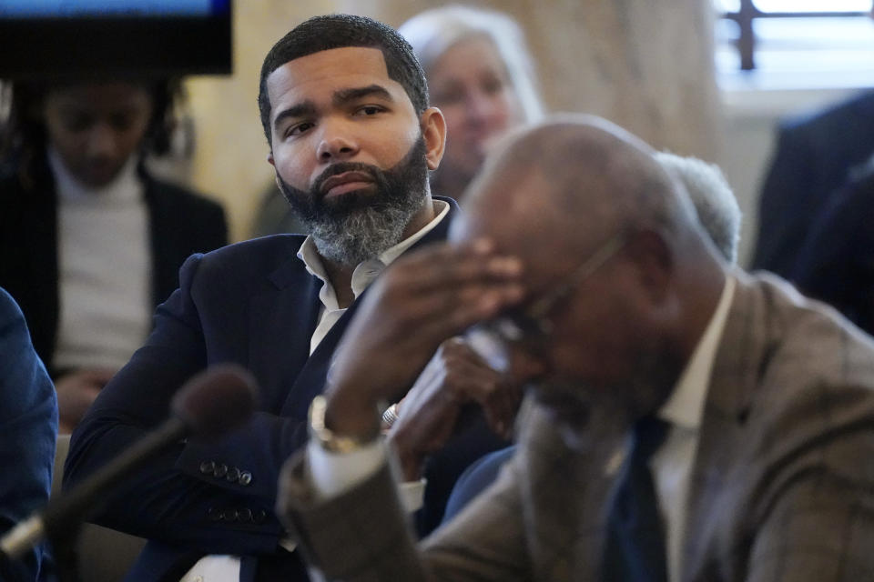 Jackson Mayor Chokwe Antar Lumumba, left, listens during a hearing hosted by the Jackson delegation of the Mississippi Legislature at the state Capitol in Jackson on Monday, March 6, 2023. The hearing was in opposition to a bill that would create courts with elected rather than appointed judges and expand the jurisdiction of the state-run Capitol Police department inside the city of Jackson. (AP Photo/Rogelio V. Solis)
