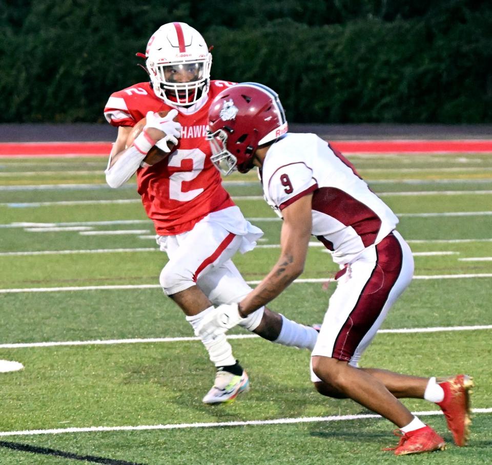 Tajardo France of Barnstable returns a kick as  Oluwakoleade Osinubi  of Brockton gets ready to tackle.