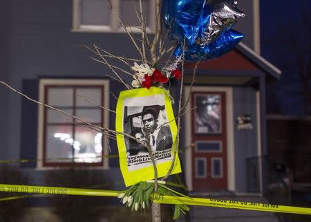 A makeshift memorial pays tribute to 19-year-old Tony Robinson, Jr., killed by police, in front of a home cordoned off with barricade tape on Williamson Street in Madison, Wisconsin March 7, 2015. REUTERS/Tom Lynn