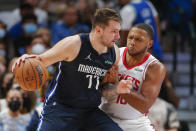 Dallas Mavericks guard Luka Doncic (77) battles Houston Rockets guard Eric Gordon (10) for space during the second half of an NBA basketball game, Tuesday, Oct. 26, 2021, in Dallas. Dallas won 116-106. (AP Photo/Brandon Wade)