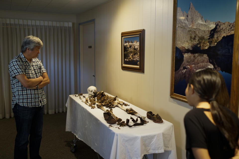 Wayne Matsumura, left, and his niece, Lilah Matsumura, look at the bones of their ancestor, Giichi Matsumura, at Brune Mortuary in Bishop, Calif., Monday, Feb. 17, 2020. Giichi Matsumura was a prisoner at the Manzanar internment camp during World War II and died on a hike in the Sierra in the waning days of the war in August 1945. Hikers discovered his mountainside grave and unearthed the skeleton in 2019, leading authorities to retrieve the bones and return them to the Matsumura family. (AP Photo/Brian Melley)