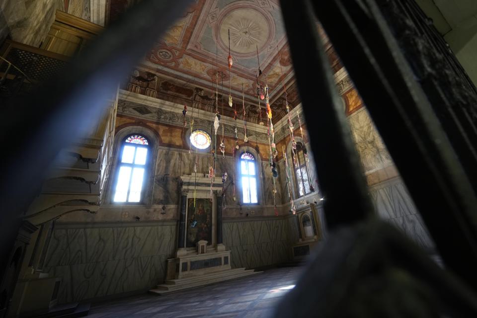 An installation by artist Sonia Gomes is displayed inside the church Santa Maria Maddalena Convertita at the women's prison of he Giudecca island during the 60th Biennale of Arts exhibition in Venice, Italy, Wednesday, April 17, 2024. A pair of nude feet dirty, wounded and vulnerable are painted on the façade of the Venice women's prison chapel, the work of Italian artist Maurizio Cattelan and part of the Vatican's pavilion at the Venice Biennale in an innovative collaboration between inmates and artists. (AP Photo/Luca Bruno)