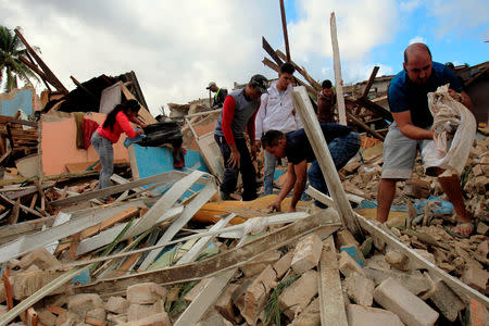 People remove debris after a tornado ripped through a neighbourhood in Havana, Cuba January 28, 2019. REUTERS/Stringer