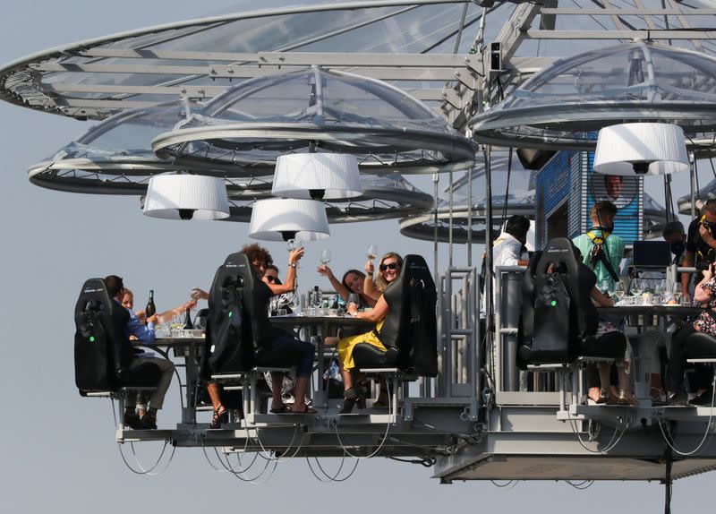 People sit at a table during "Dinner in the Sky 2.0 New Generation” in Brussels