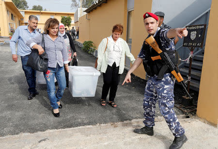 Government election officials carry ballot boxes which will be located in polling stations ahead of the country's May 6 parliamentary election, in Beirut, Lebanon, May 5, 2018. REUTERS/Mohamed Azakir