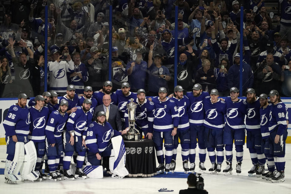 Members of the Tampa Bay Lightning pose for a photo with the Prince of Wales trophy after defeating the New York Islanders during Game 7 of an NHL hockey Stanley Cup semifinal playoff series Friday, June 25, 2021, in Tampa, Fla. (AP Photo/Chris O'Meara)