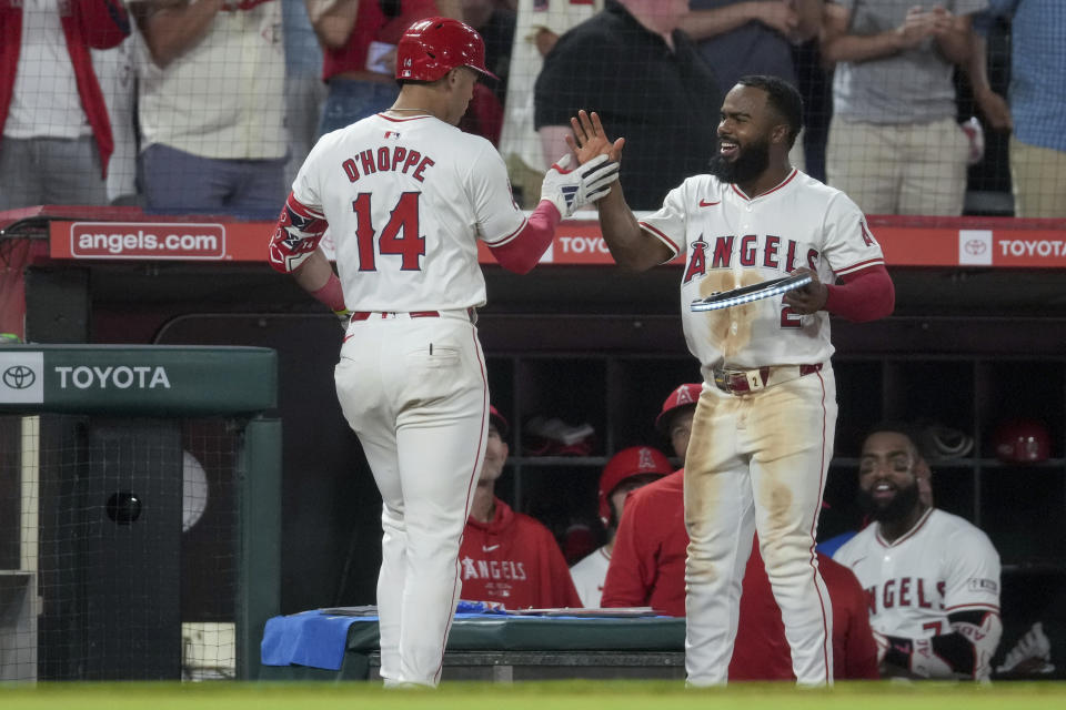 Los Angeles Angels' Logan O'Hoppe (14) is congratulated by Luis Rengifo after O'Hoppe hit a home run against the Detroit Tigers during the eighth inning of a baseball game in Anaheim, Calif., Saturday, June 29, 2024. (AP Photo/Eric Thayer)