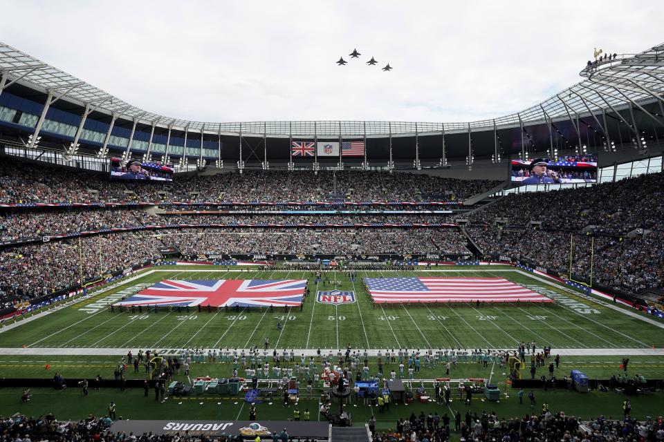 Jets flyover as the United Kingdom and United States flags are presented on the field before an NFL football game between the Jacksonville Jaguars and the Miami Dolphins at Tottenham Hotspur Stadium in London, Sunday, Oct. 17, 2021. (AP Photo/Steve Luciano)