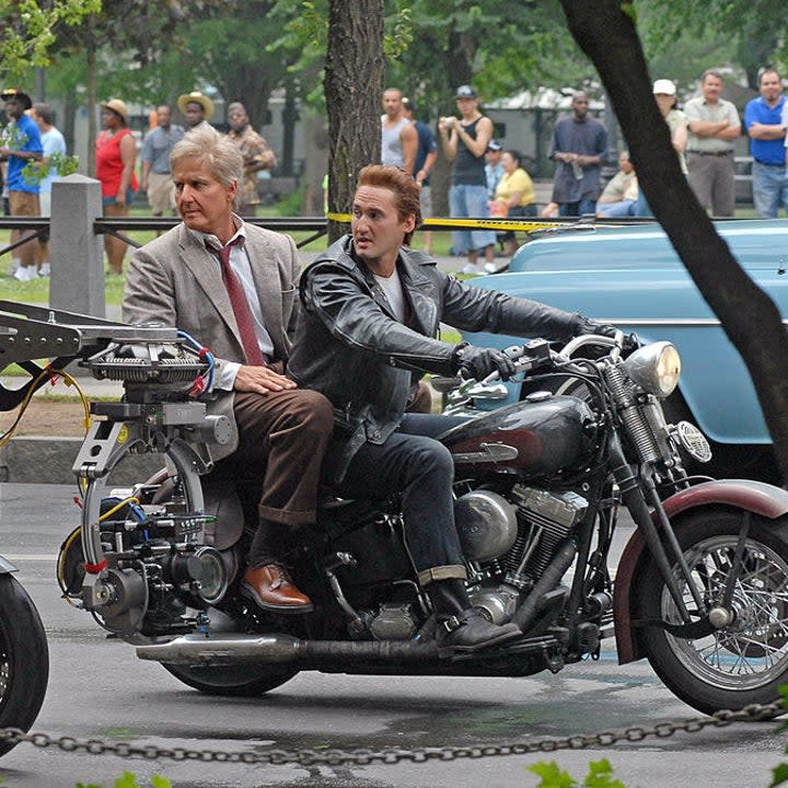 The body doubles riding a motorcycle outdoors