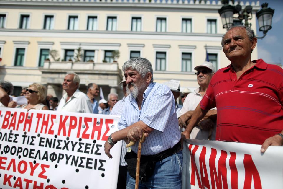 Pensioners take part in a rally against healthcare cuts as the banner reads "the burdens of the crisis'' in Athens, on Saturday, Sept. 8, 2012. Greece, in the grip of a severe recession for the fifth straight year, is still struggling to avoid bankruptcy by imposing harsh austerity measures, including wage and pension cuts, with unemployment increasing to nearly a quarter of the workforce.(AP Photo/Petros Giannakouris)