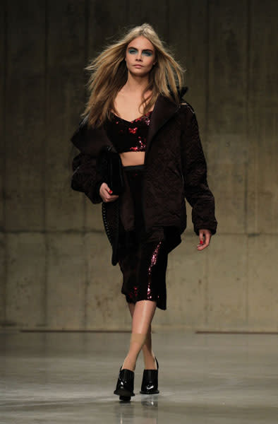 <b>LFW AW13: Topshop Unique </b><br><br>Cara Delevingne modelled a red sequinned bralet and pencil skirt.<br><br>© PA