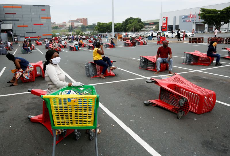 Shoppers queue at a grocery store during a nationwide 21 day lockdown in an attempt to contain the coronavirus disease (COVID-19) outbreak in Chatsworth near Durban