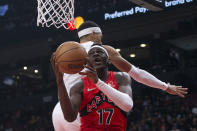 Toronto Raptors' Isaac Bonga (17) shoots around Oklahoma City Thunder's Darius Bazley during the first half of an NBA basketball game Wednesday, Dec. 8, 2021, in Toronto. (Chris Young/The Canadian Press via AP)