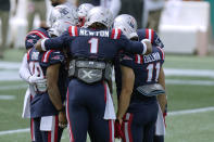 New England Patriots quarterback Cam Newton (1) huddles with New England Patriots wide receivers Damiere Byrd (10) and Julian Edelman (11) and teammates as they warm up before an NFL football game, Sunday, Sept. 13, 2020, in Foxborough, Mass. (AP Photo/Steven Senne)