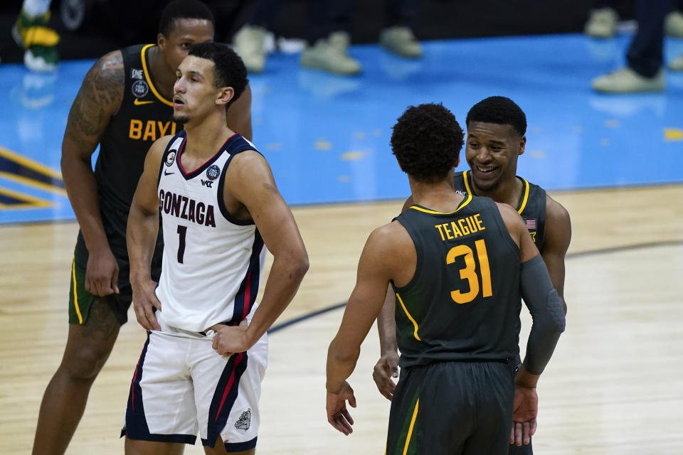 Baylor guard Jared Butler, right, celebrates with teammate guard MaCio Teague (31) in front of Gonzaga guard Jalen Suggs (1) at the end of the championship game in the men's Final Four NCAA college basketball tournament, Monday, April 5, 2021, at Lucas Oil Stadium in Indianapolis. (AP Photo/Michael Conroy)