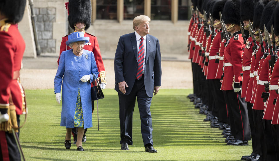 The Queen walks with President Trump as they inspect the Coldstream guards at Windsor castle. [Photo: Getty]