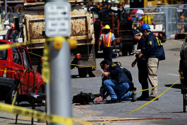 <p>Greg Smith/CORBIS/Corbis via Getty</p> FBI and ATF agents search a car transmission