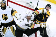 Vegas Golden Knights defenseman Deryk Engelland (5) tries to clear Boston Bruins Anton Blidh, right, away from the goal during the first period of an NHL hockey game in Boston, Tuesday, Jan. 21, 2020. (AP Photo/Charles Krupa)