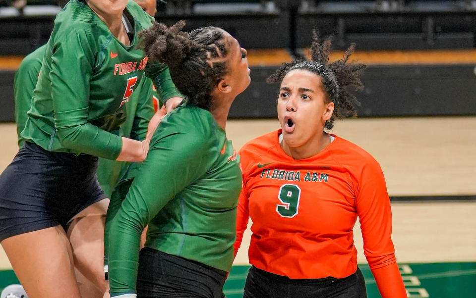 Florida A&M libero Brooke Hudson celebrates after a play with outside hitter Brooke Lynn Watts during a volleyball match.