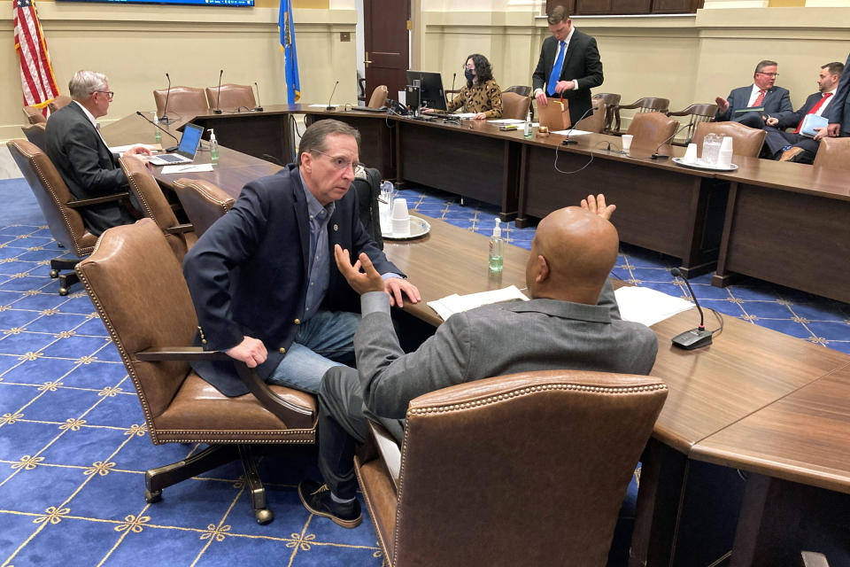 FILE- Don Spencer, left, the president of the Oklahoma 2nd Amendment Association, speaks to state Sen. Kevin Matthews after a meeting at the Oklahoma State Capitol on Monday, Feb. 14, 2022, in Oklahoma City. The pro-firearms association was little-known a decade ago but has grown into a formidable political player at the state Capitol. (AP Photo by Sean Murphy_File)