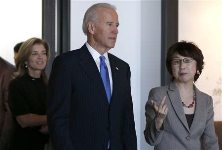 U.S. Vice President Joe Biden (C) and U.S. Ambassador to Japan Caroline Kennedy (L) inspect the headquarters of internet commerce and mobile games provider DeNA Co with the company's founder Tomoko Namba in Tokyo December 3, 2013. REUTERS/Toru Hanai