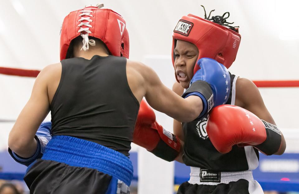 Khaine Charles (left), of Canton, lands a punch on his opponent, Marvin Spencer, during Brawl at the Hall of Fame Village on Saturday night. Charles won the bout by the judges' decision.