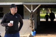 Trainer Chad Brown stands outside his barn after taking his horses for a workout at Churchill Downs Monday, April 29, 2024, in Louisville, Ky. The 150th running of the Kentucky Derby is scheduled for Saturday, May 4. (AP Photo/Charlie Riedel)