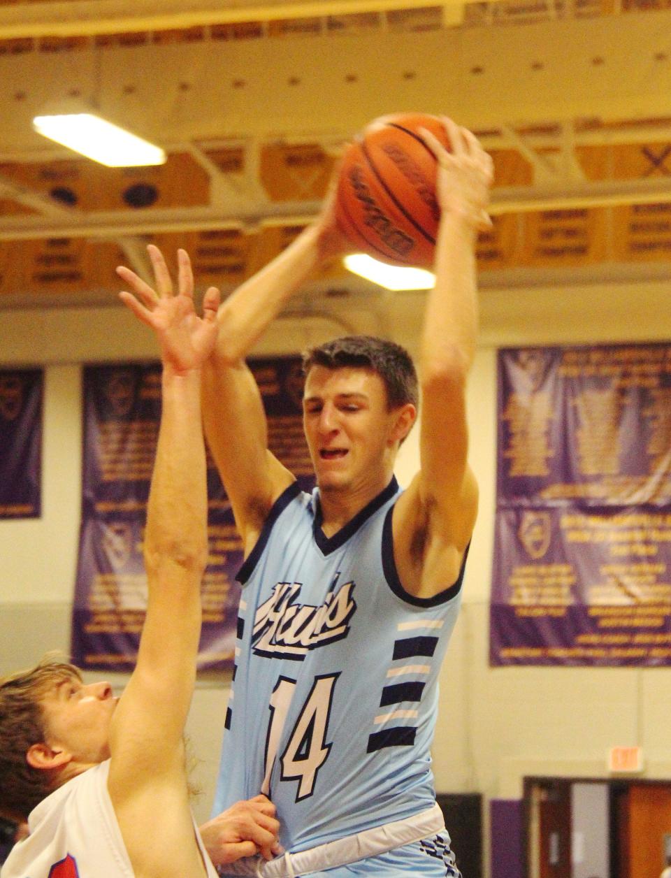 Dylan Bazzell grabs a rebound for Prairie Central in its IPC-Sangamo Shootout game with Pleasant Plains Saturday. The Hawks won 41-27.