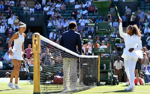 US player Serena Williams (R) and Netherlands' Arantxa Rus arrive on court for their women's singles first round match on the first day of the 2018 Wimbledon Championships at The All England Lawn Tennis Club in Wimbledon, southwest London, on July 2, 2018 - Credit: AFP