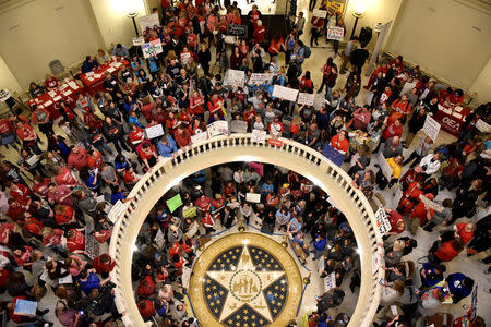 FILE PHOTO - Teachers pack the state Capitol rotunda to capacity, on the second day of a teacher walkout, to demand higher pay and more funding for education, in Oklahoma City, Oklahoma, U.S., April 3, 2018. REUTERS/Nick Oxford