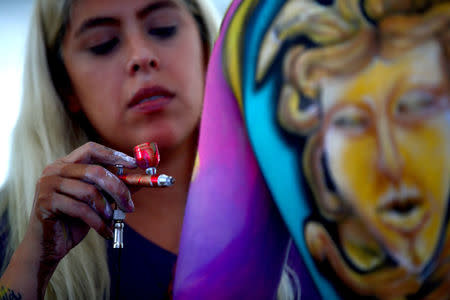 An artist paints a model during the "World Bodypainting Festival 2018" in Klagenfurt, Austria, July 13, 2018. REUTERS/Lisi Niesner