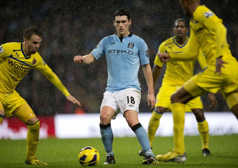 Manchester City's midfielder Gareth Barry fights for the ball during their Premiership football match against Reading at The Etihad stadium in Manchester, northwest of England on December 22, 2012. Barry scored an injury-time winner and Manchester City won the game 1-0
