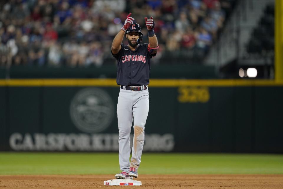 Cleveland Guardians' Amed Rosario celebrates his run-scoring, ground-rule double in the eighth inning of a baseball game against the Texas Rangers in Arlington, Texas, Saturday, Sept. 24, 2022. Myles Straw scored on the play. (AP Photo/Tony Gutierrez)