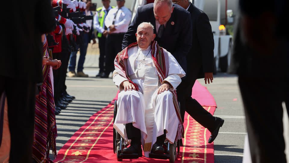 Pope Francis wears a scarf he was presented with when he arrived in Dili, East Timor, September 9. - Guglielmo Mangiapane/Reuters