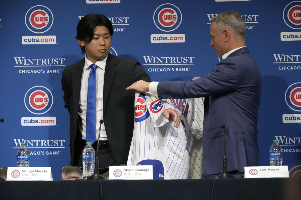 New Chicago Cubs pitcher Shōta Imanaga is presented with his jersey by Cubs president of baseball operations Jed Hoyer, right, during a news conference Friday, Jan. 12, 2024, in Chicago. The Japanese left-hander is expected to step right into the baseball team's rotation as it tries to return to the playoffs for the first time since 2020. (AP Photo/Nam Y. Huh)