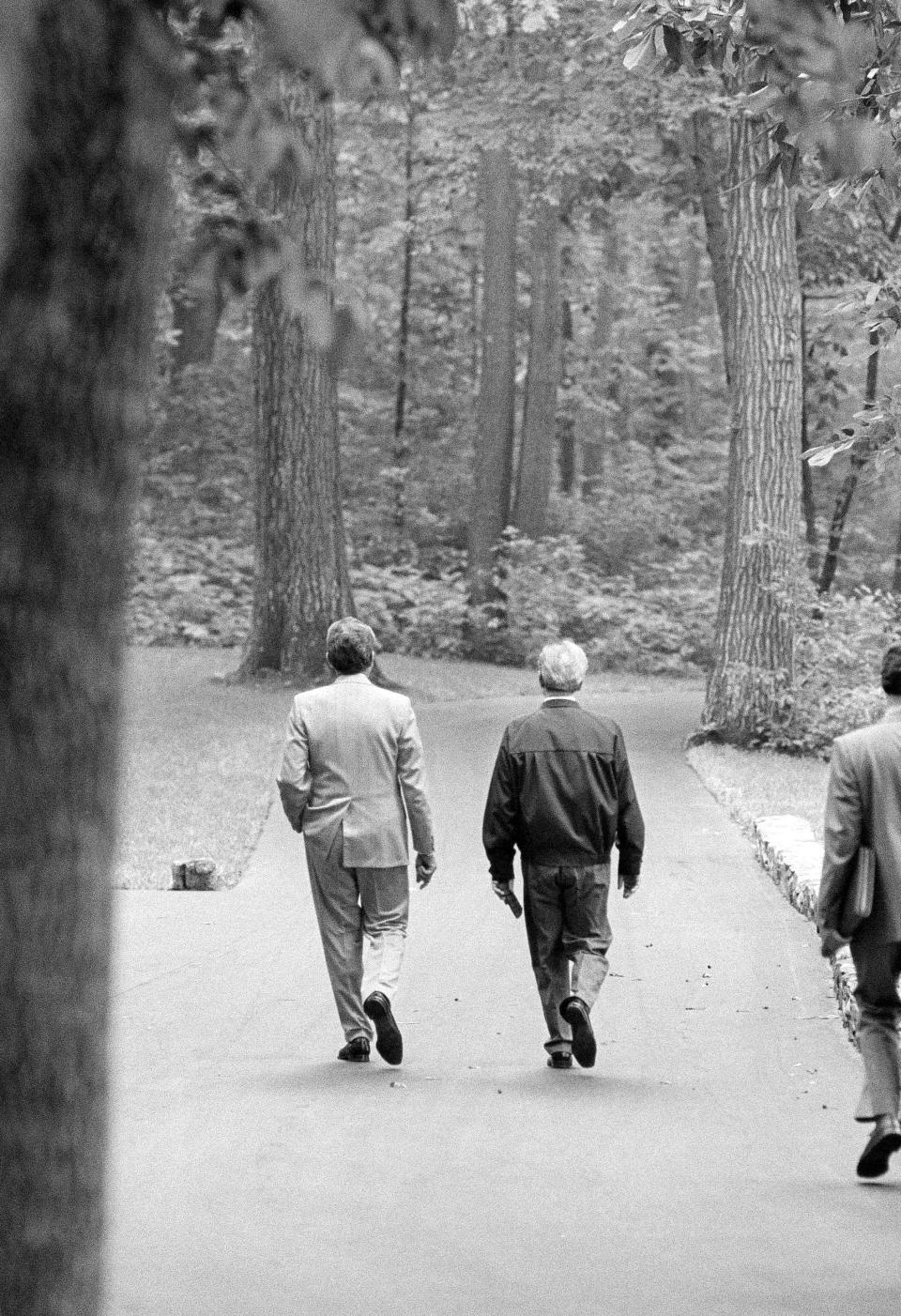 Soviet leader Leonid I. Brezhnev, right, and President Richard Nixon walk down a path at the presidential retreat at Camp David, Md., June 20, 1973, as they hold talks.