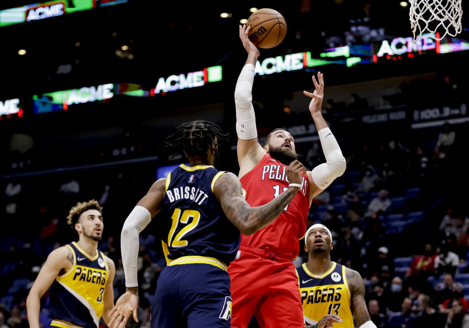 New Orleans Pelicans center Jonas Valanciunas, second from right, shoots over Indiana Pacers forwards Oshae Brissett (12) and Torrey Craig (13) in the third quarter of an NBA basketball game in New Orleans, Monday, Jan. 24, 2022. (AP Photo/Derick Hingle)
