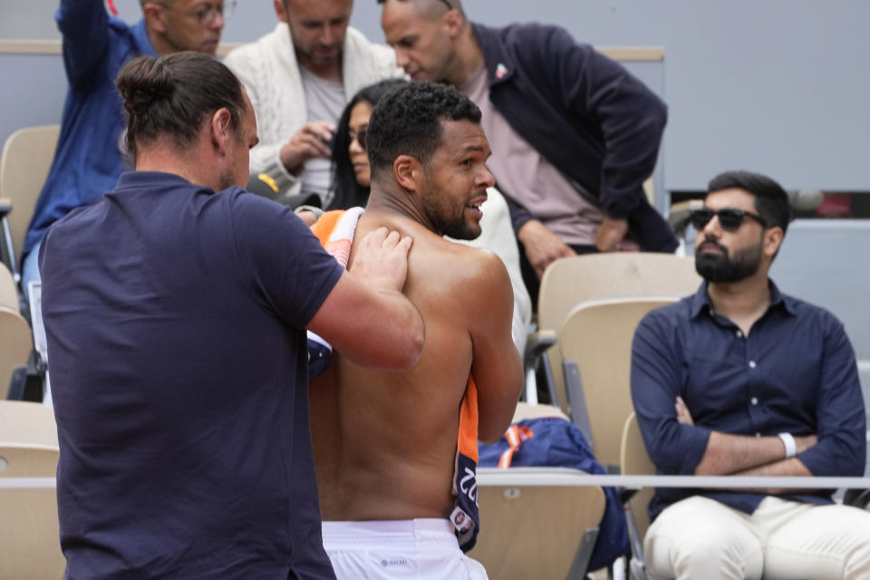 France's Jo-Wilfried Tsonga is being treated as he plays Norway's Casper Ruud during a first round match of the French Open tennis tournament at the Roland Garros stadium Tuesday, May 24, 2022 in Paris. (AP Photo/Michel Euler)