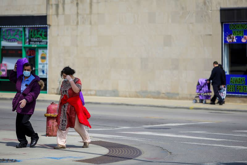 Pedestrians walk along Devon Avenue during the global outbreak of coronavirus disease (COVID-19) in Chicago