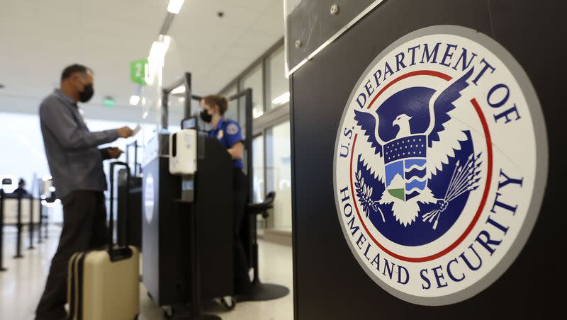 Staci Merten, a transportation security officer with the Transportation Security Administration, checks a passenger’s identification at the TSA security checkpoint at Salt Lake City International Airport in Salt Lake City on Tuesday, May 18, 2021.